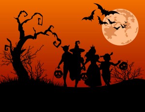 Halloween background with silhouettes of children trick or treating in Halloween costume